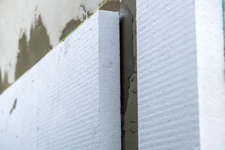 Installation of styrofoam thermal insulation materials sheets for house facade wall